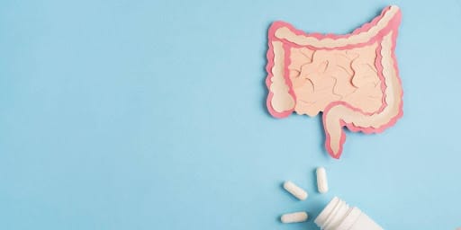 Desenho de intestino em fundo azul com alguns remédios